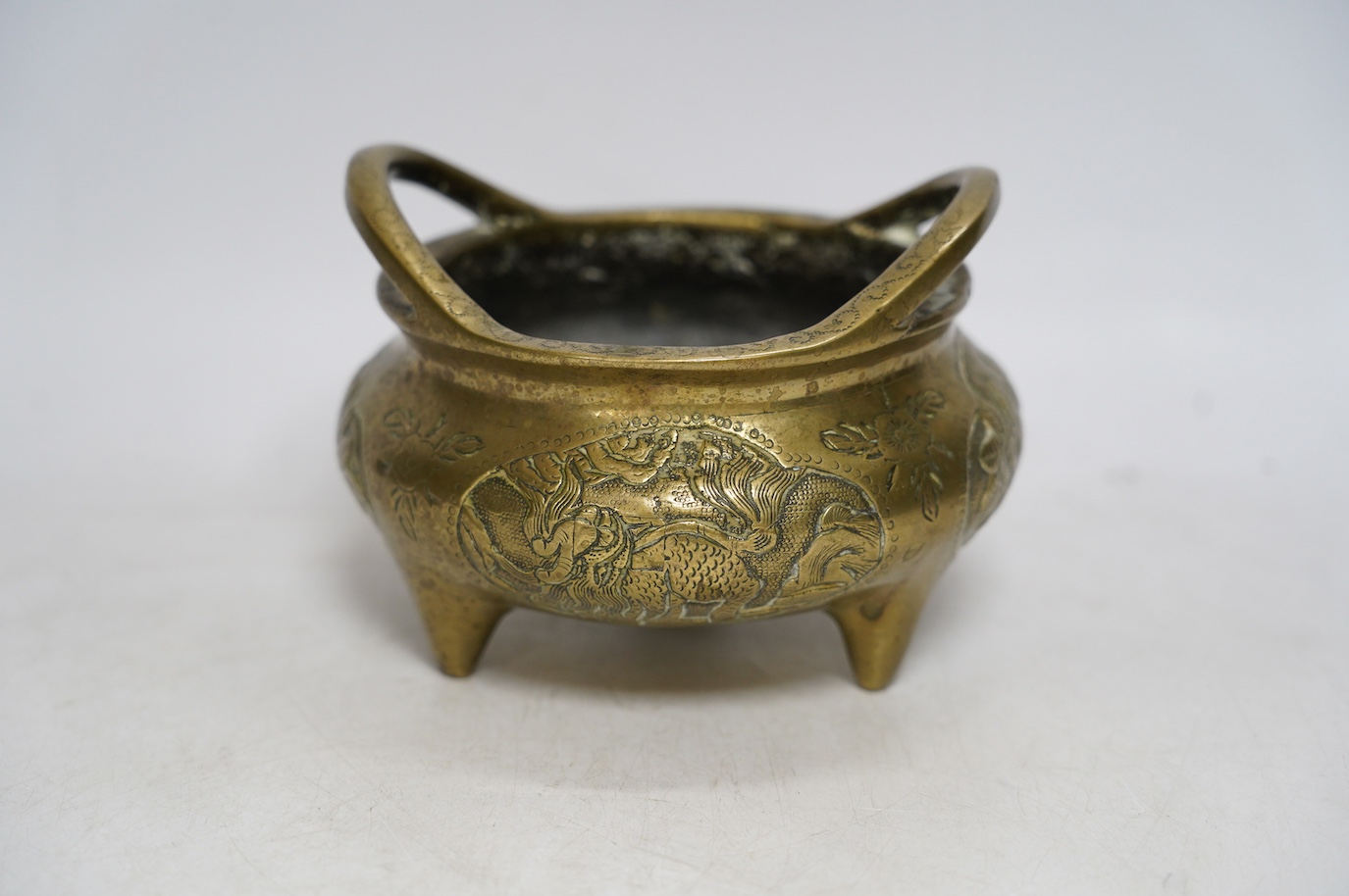 A Chinese bronze tripod censer, Xuande mark, 19th century, 13cm wide. Condition - plug repair to body